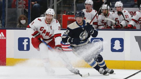 Oct 23, 2021; Columbus, Ohio, USA; Carolina Hurricanes center Jordan Staal (11) and Columbus Blue Jackets center Alexandre Texier (42) battle for the puck during the first period at Nationwide Arena.