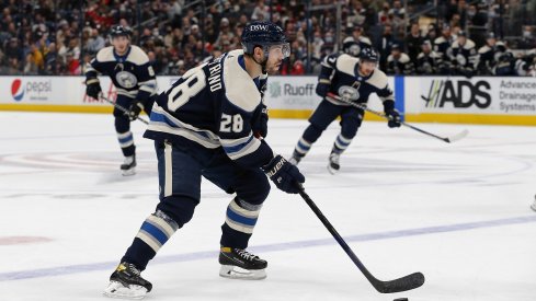 Oliver Bjorkstrand skates with the puck