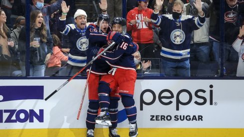 Columbus Blue Jackets forwards Patrik Laine and Max Domi celebrating a goal at Nationwide Arena.