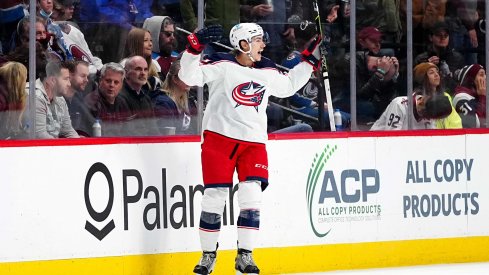 Nov 3, 2021; Denver, Colorado, USA; Columbus Blue Jackets defenseman Jake Bean (22) celebrates his overtime winning goal against the Colorado Avalanche at Ball Arena.