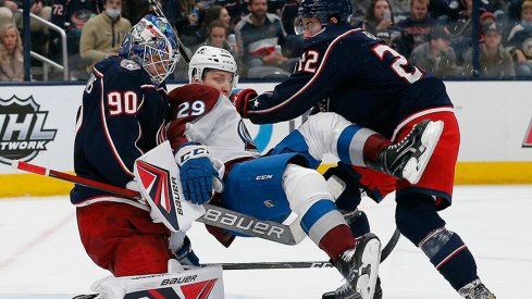 Columbus Blue Jackets goalie Elvis Merzlikins (90) makes a save against Colorado Avalanche center Nathan MacKinnon (29)