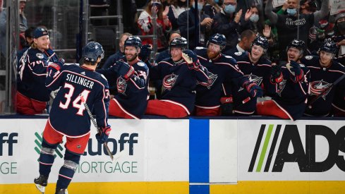 Oct 21, 2021; Columbus, Ohio, USA; Columbus Blue Jackets center Cole Sillinger (34) celebrates with his team after scoring a goal against the New York Islanders in the second period at Nationwide Arena.