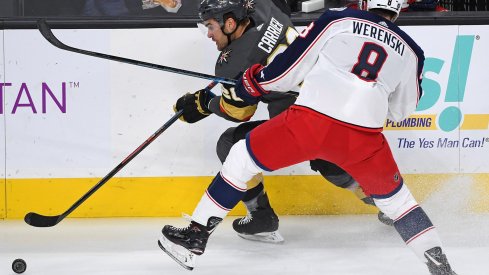 Feb 9, 2019; Las Vegas, NV, USA; Columbus Blue Jackets defenseman Zach Werenski (8) checks Vegas Golden Knights left wing William Carrier (28) during the first period at T-Mobile Arena.