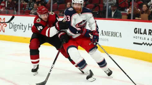 Jakub Voracek protects the puck against Arizona Coyotes defenseman Ilya Lyubushkin