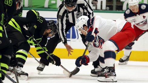 Dallas Stars center Andrew Cogliano (11) and Columbus Blue Jackets center Jack Roslovic (96) in a face off in the second period at American Airlines Center.