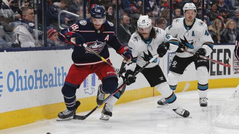 Jan 4, 2020; Columbus, Ohio, USA; Columbus Blue Jackets center Boone Jenner (38) and San Jose Sharks defenseman Erik Karlsson (65) battle for the puck during the second period at Nationwide Arena.