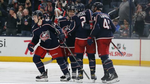 Columbus Blue Jackets' Jack Roslovic celebrates his third period goal against the San Jose Sharks with teammates at Nationwide Arena.