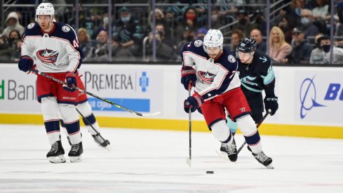 Dec 11, 2021; Seattle, Washington, USA; Columbus Blue Jackets center Sean Kuraly (7) advances the puck against the Seattle Kraken during the first period at Climate Pledge Arena.