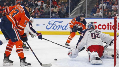 Dec 16, 2021; Edmonton, Alberta, CAN; Edmonton Oilers forward Jesse Puljujarvi (13) scores a first period goal against Columbus Blue Jackets goaltender Elvis Merzlikins (90) at Rogers Place.