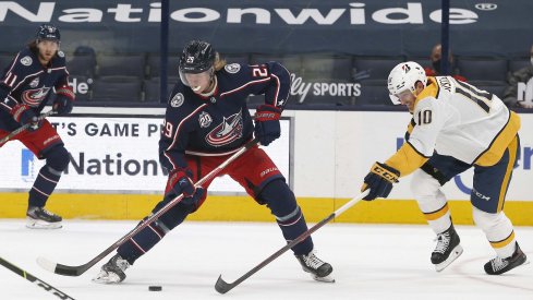 May 5, 2021; Columbus, Ohio, USA; Nashville Predators center Colton Sissons (10) knocks the puck off the stick of Columbus Blue Jackets right wing Patrik Laine (29) during the first period at Nationwide Arena.