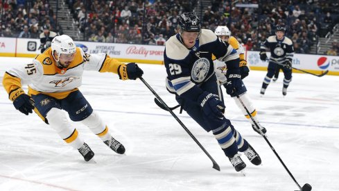 Patrik Laine skates with the puck around defenseman Alexandre Carrier at Nationwide Arena.