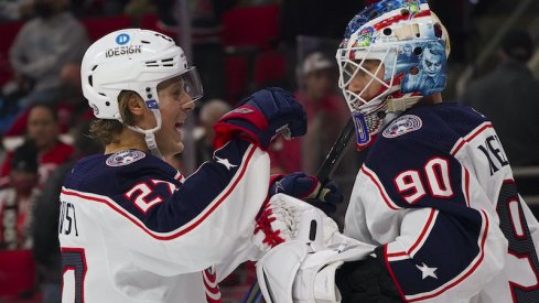 Columbus Blue Jackets' Adam Boqvist and Elvis Merzlikins celebrate their 6-0 over the Carolina Hurricanes at PNC Arena.