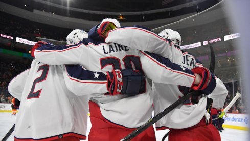 Columbus Blue Jackets' Patrik Laine celebrates his goal with Andrew Peeke and Boone Jenner against the Philadelphia Flyers at Wells Fargo Center.