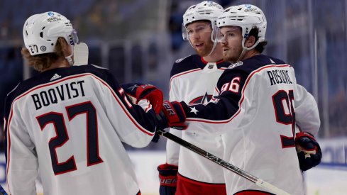 Feb 10, 2022; Buffalo, New York, USA; Columbus Blue Jackets center Jack Roslovic (96) celebrates his goal with teammates during the first period against the Buffalo Sabres at KeyBank Center.