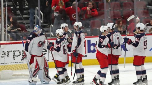 Feb 17, 2022; Chicago, Illinois, USA; The Columbus Blue Jackets celebrate their victory over the Chicago Blackhawks following the third period at the United Center.