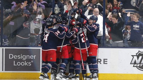 Feb 22, 2022; Columbus, Ohio, USA; The Columbus Blue Jackets celebrate the overtime win against the Toronto Maple Leafs at Nationwide Arena.