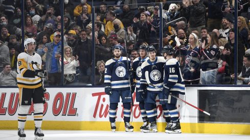 Jack Roslovic celebrates a goal with teammates