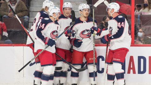 The Columbus Blue Jackets celebrate a goal scored by center Jack Roslovic in the first period against the Ottawa Senators at the Canadian Tire Centre.
