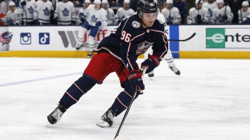 Columbus Blue Jackets' Jack Roslovic playing the puck against the Toronto Maple Leafs at Nationwide Arena.