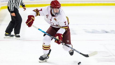 Aidan Hreschuk settles the puck as he skates down the ice for the Boston College Eagles
