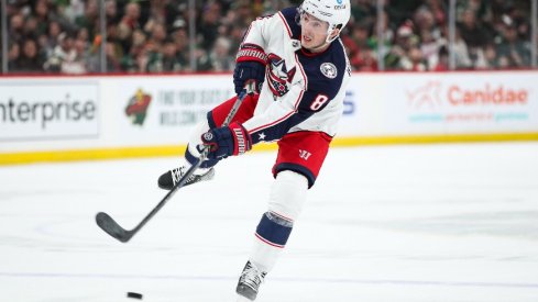 Columbus Blue Jackets defenseman Zach Werenski (8) shoots the puck against the Minnesota Wild in the first period at Xcel Energy Center. 