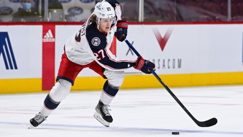 Adam Boqvist skates the puck