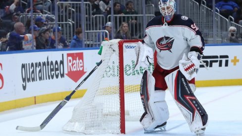 Columbus Blue Jackets goaltender Elvis Merzlikins (90) stick is stuck in the goal netting during the second period against the New York Islanders at UBS Arena. 