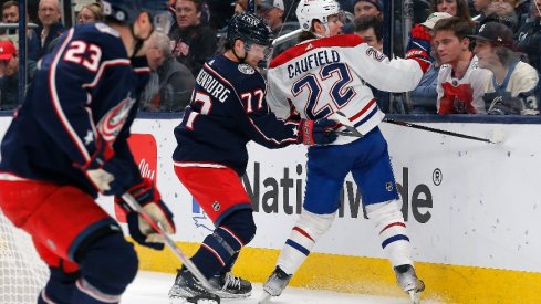 Columbus Blue Jackets defenseman Nick Blankenburg (77) checks Montreal Canadiens right wing Cole Caufield (22) during the first period at Nationwide Arena.