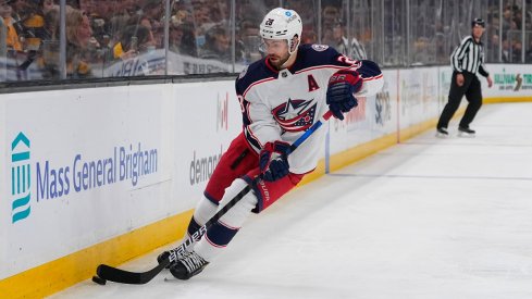 Oliver Bjorkstrand skates with the puck