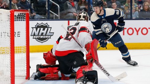 Columbus Blue Jackets center Jack Roslovic reaches for the rebound of a Ottawa Senators goalie Filip Gustavsson save during the second period at Nationwide Arena.