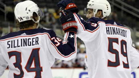 Columbus Blue Jackets' Yegor Chinakhov and Cole Sillinger celebrate a goal against the Pittsburgh Penguins during the first period at PPG Paints Arena.