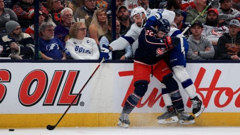 Columbus Blue Jackets defenseman Jake Bean checks Tampa Bay Lightning left wing Nicholas Paul along the boards in the third period at Nationwide Arena.