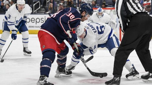 Columbus Blue Jackets center Boone Jenner and Toronto Maple Leafs center David Kampf face-off in the first period at Nationwide Arena.