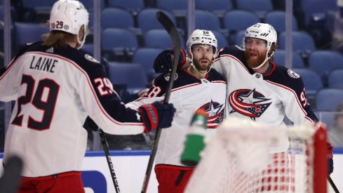 Columbus Blue Jackets right wing Oliver Bjorkstrand celebrates his goal with left wing Patrik Laine and right wing Jakub Voracek during the third period against the Buffalo Sabres.