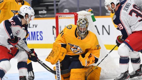 Nashville Predators goaltender Juuse Saros makes a save against traffic from Columbus Blue Jackets center Alexandre Texier and center Boone Jenner during the second period.