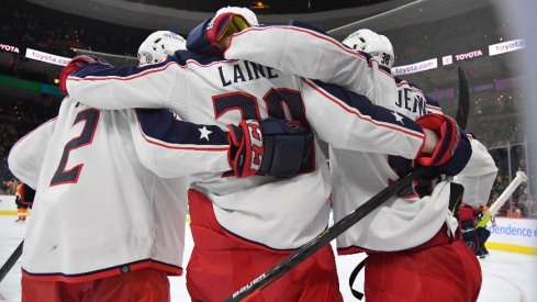 Columbus Blue Jackets left wing Patrik Laine celebrates his goal with defenseman Andrew Peeke and center Boone Jenner against the Philadelphia Flyers during the third period. 