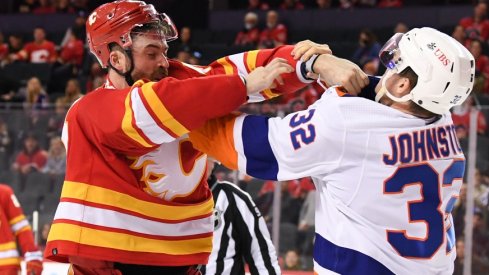 Calgary Flames defenseman Erik Gudbranson  fights with New York Islanders forward Ross Johnston during the second period at Scotiabank Saddledome.