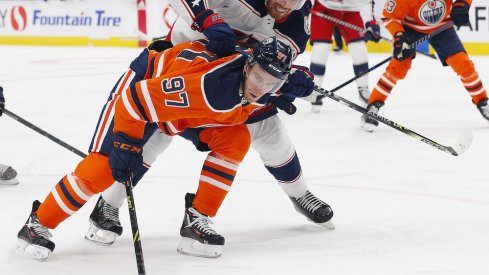 Vladislav Gavrikov defending Connor McDavid