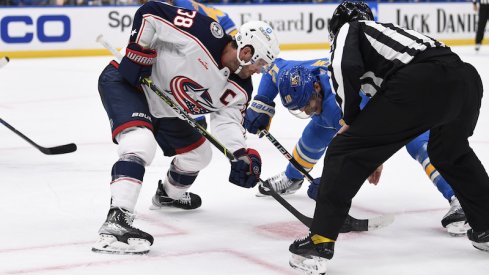 Columbus Blue Jackets' Boone Jenner takes the face-off against St. Louis Blues center Brayden Schenn during the second period at Enterprise Center.
