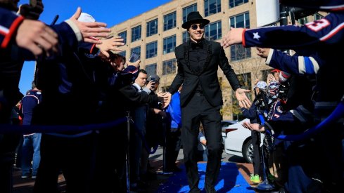 Columbus Blue Jackets goaltender Elvis Merzlikins high-fives fans as he walks the Blue Carpet prior to the game against the Tampa Bay Lightning at Nationwide Arena.