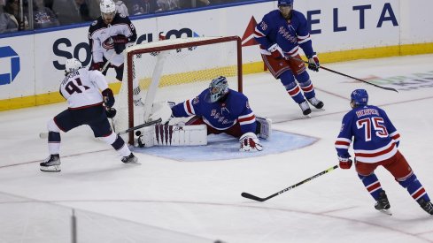 Kent Johnson scores a goal against New York Rangers goaltender Jaroslav Halak