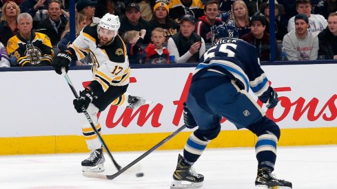 Boston Bruins left wing Nick Foligno shoots against Columbus Blue Jackets defenseman David Jiricek during the first period at Nationwide Arena.