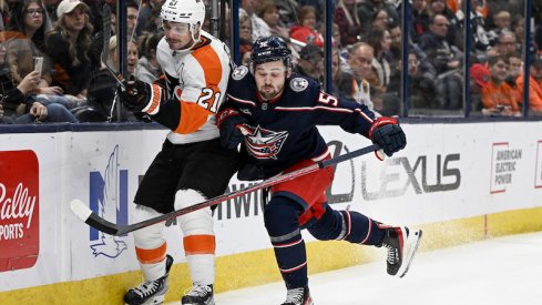 Columbus Blue Jackets' Emil Bemstrom checks Philadelphia Flyers' Scott Laughton against the boards in the second period at Nationwide Arena.