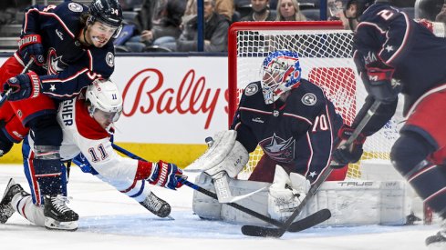 Montreal Canadiens' Brendan Gallagher shoots the puck as Columbus Blue Jackets' Cole Sillinger knocks him down in front of Columbus Blue Jackets goaltender Joonas Korpisalo (70) in the second period at Nationwide Arena.