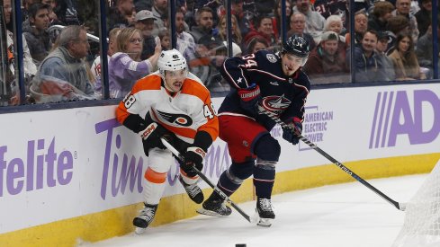 Cole Sillinger battles for control of a loose puck during the first period at Nationwide Arena