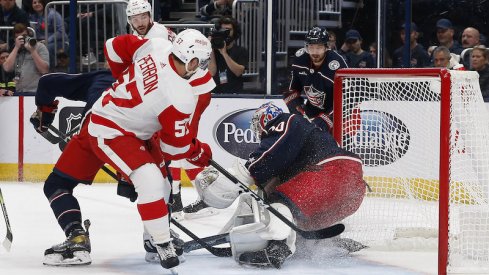 Columbus Blue Jackets' Joonas Korpisalo makes a save as Detroit Red Wings' David Perron looks for a rebound during the third period at Nationwide Arena.