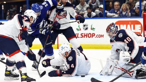 Tampa Bay Lightning' Corey Perry shoots the puck as Columbus Blue Jackets Vladislav Gavrikov and goaltender Daniil Tarasov defend during the first period at Amalie Arena.