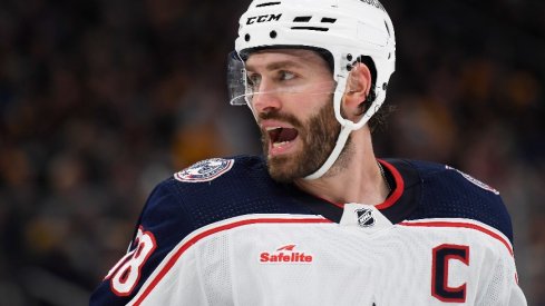 Columbus Blue Jackets center Boone Jenner has words with one of the Boston Bruins during the second period at TD Garden.