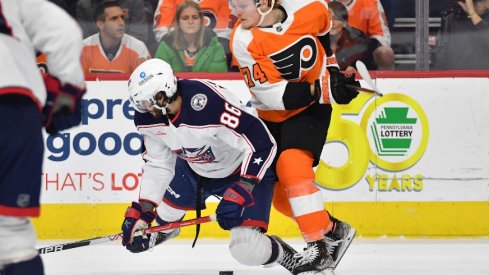 Columbus Blue Jackets right wing Kirill Marchenko and Philadelphia Flyers right wing Owen Tippett battle for the puck during the second period at Wells Fargo Center.