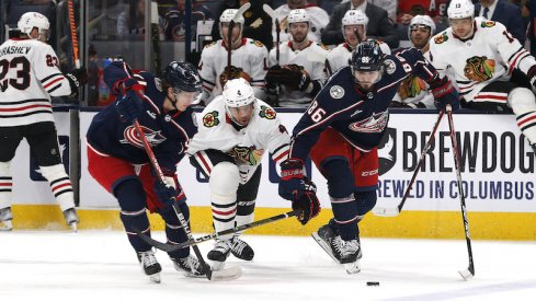 Chicago Blackhawks' Seth Jones and Columbus Blue Jackets' Kirill Marchenko chase down a loose puck during the first period at Nationwide Arena.